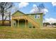 Two-story house with a deck and stairs leading to the backyard at 153 Oak St, Hiram, GA 30141