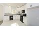 Modern kitchen, white cabinets, granite counters, black appliances at 153 Oak St, Hiram, GA 30141
