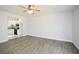 Open living area with hardwood floors, kitchen access and ceiling fan at 153 Oak St, Hiram, GA 30141