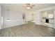 Open concept living room, grey walls, wood-look flooring, and kitchen view at 153 Oak St, Hiram, GA 30141