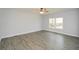 Spacious living room with light grey walls, wood-look flooring and ceiling fan at 153 Oak St, Hiram, GA 30141