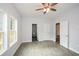 Main bedroom with hardwood floors, ceiling fan and access to bathroom at 153 Oak St, Hiram, GA 30141