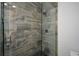 Walk-in shower with modern gray tile and glass enclosure at 153 Oak St, Hiram, GA 30141