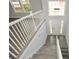 View of a staircase leading to the second floor, with white railings and grey flooring at 153 Oak St, Hiram, GA 30141