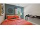 Cozy bedroom with coral bedding, a desk, and teal accent wall at 2096 Moss Hill Road, Stone Mountain, GA 30088