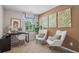Bright home office features a desk, two armchairs, and stylish wall art at 2096 Moss Hill Road, Stone Mountain, GA 30088