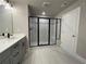 This bathroom offers a double sink vanity with a glass-enclosed shower and a door at 391 Lincoln St, Woodstock, GA 30188