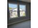 This cozy bedroom boasts large windows with lots of natural light and serene outdoor views at 391 Lincoln St, Woodstock, GA 30188