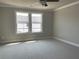 This bedroom has plush carpet and an abundance of natural light from the double windows at 391 Lincoln St, Woodstock, GA 30188