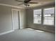 This bedroom offers carpeted floors, a ceiling fan, and double windows for ample natural light at 391 Lincoln St, Woodstock, GA 30188