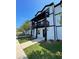 Charming two-story exterior showcases a balcony and well-manicured lawn, blending comfort with modern aesthetics at 391 Lincoln St, Woodstock, GA 30188