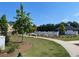 Beautifully landscaped common area with walking path, seating, and community amenities at 391 Lincoln St, Woodstock, GA 30188