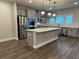 Modern kitchen with stainless steel appliances, sleek countertops, and pendant lighting above the center island at 391 Lincoln St, Woodstock, GA 30188