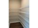 Walk-in pantry features built-in shelving and wood flooring at 391 Lincoln St, Woodstock, GA 30188