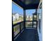 Covered patio with black wooden railing overlooks a residential community at 391 Lincoln St, Woodstock, GA 30188