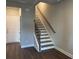 Inviting staircase with wood and iron details leading to the upper level of this newly constructed home at 391 Lincoln St, Woodstock, GA 30188
