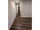 Interior hallway with dark brown wood-look flooring at 97 Paces Overlook Trce, Dallas, GA 30157