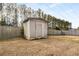 Tan shed in backyard with wooden fence and trees at 3111 Green Gate Se Way, Conyers, GA 30013