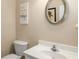 Simple half bathroom with white vanity and oval mirror at 3111 Green Gate Se Way, Conyers, GA 30013