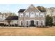 Two-story brick home with a large front yard and landscaping at 3111 Green Gate Se Way, Conyers, GA 30013