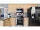 Kitchen features stainless steel appliances and light beige cabinets at 3111 Green Gate Se Way, Conyers, GA 30013