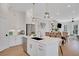 White kitchen with island, stainless steel appliances, and breakfast bar at 500 Clover Ln, Alpharetta, GA 30009