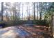 Large backyard with wooded area and a storage trailer at 8045 Woodlake Dr, Riverdale, GA 30274