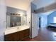 Ensuite bathroom with a large vanity and a view to the main bedroom at 8045 Woodlake Dr, Riverdale, GA 30274