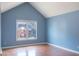 Well-lit bedroom boasts a large window with views of the neighborhood and stylish wood flooring at 8045 Woodlake Dr, Riverdale, GA 30274