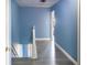 Upstairs hallway with fresh blue paint and modern wood-look floors at 8045 Woodlake Dr, Riverdale, GA 30274