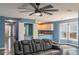 Open-concept living area with modern ceiling fan and convenient bar area that connects to kitchen at 8045 Woodlake Dr, Riverdale, GA 30274