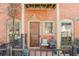 Inviting front porch with brick facade and tranquil seating area at 3371 Dogwood Dr # 120, Hapeville, GA 30354