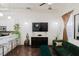 Living room with dark floors, green velvet sofa, and large TV at 3371 Dogwood Dr # 120, Hapeville, GA 30354