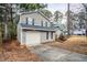 Two-story house with gray siding, red door, and attached garage at 6179 Dana Ct, Lithonia, GA 30058