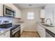 Modern kitchen with stainless steel appliances and granite countertops at 6179 Dana Ct, Lithonia, GA 30058