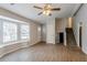 Living room with hardwood floors, bay window, and ceiling fan; stairs to upper level at 6179 Dana Ct, Lithonia, GA 30058