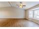 Large living area with hardwood floors, bay window, and ceiling fan at 6179 Dana Ct, Lithonia, GA 30058