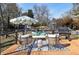 Relaxing deck with lounge furniture and umbrella, overlooking a backyard at 1608 Carroll Nw Dr, Atlanta, GA 30318