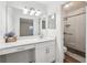 Modern bathroom featuring a glass-enclosed shower with tiled walls and a dual sink vanity with makeup counter at 1608 Vicksburg Pl, Sandy Springs, GA 30350