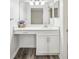 Bathroom showcasing a vanity area with white cabinets and ample lighting, complimented by attractive vinyl flooring at 1608 Vicksburg Pl, Sandy Springs, GA 30350