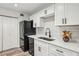 Well-lit kitchen featuring white cabinets, a modern faucet, and a stylish backsplash at 1608 Vicksburg Pl, Sandy Springs, GA 30350