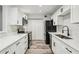 Bright kitchen featuring modern appliances, white cabinets, and stylish flooring at 1608 Vicksburg Pl, Sandy Springs, GA 30350