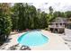 Community pool with lounge chairs and deck surrounded by lush trees at 1608 Vicksburg Pl, Sandy Springs, GA 30350