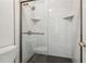 Clean walk-in shower with dark hexagon floor tiles at 1608 Vicksburg Pl, Sandy Springs, GA 30350