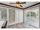 Light-filled sunroom with sliding glass doors to a patio or balcony and featuring vinyl flooring at 1608 Vicksburg Pl, Sandy Springs, GA 30350