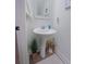 Clean bathroom with pedestal sink, decorative accents, and wood-look floors at 4940 Parke Brook Dr, Acworth, GA 30101