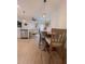Kitchen dining area with light wood LVP flooring and a view into living room at 4940 Parke Brook Dr, Acworth, GA 30101