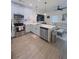 Modern kitchen with white cabinets, stainless steel appliances, and LVP flooring at 4940 Parke Brook Dr, Acworth, GA 30101