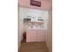 Well-organized laundry room, washer, dryer, and shelves at 4940 Parke Brook Dr, Acworth, GA 30101