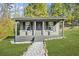 Gray cottage with covered porch and stone pathway at 6585 Queen Mill Se Rd, Mableton, GA 30126